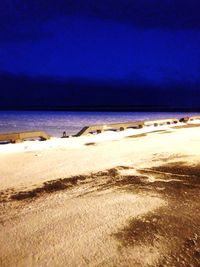 Scenic view of beach against blue sky