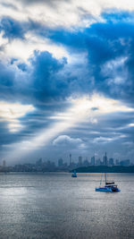 Sailboats in sea against sky