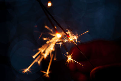 Close-up of lit sparkler at night