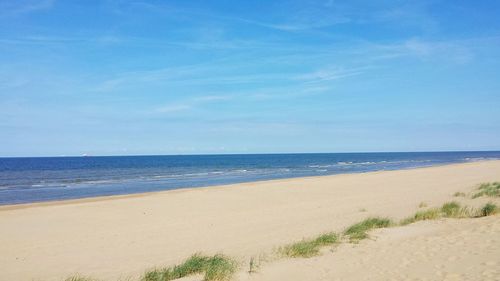 View of beach against blue sky