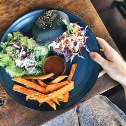 Cropped hand of person having food on table