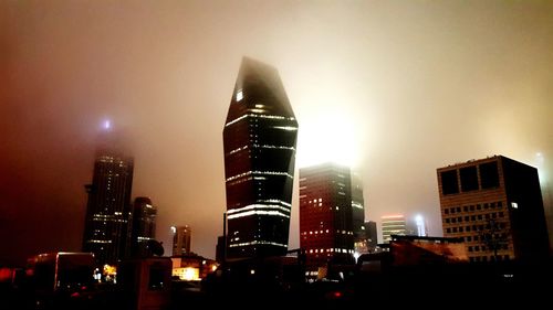 Low angle view of modern office building at night