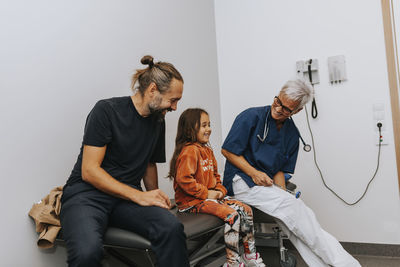 Father with daughter in doctors office