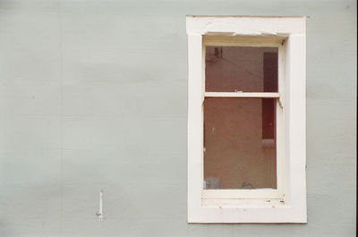 Full frame shot of window on white wall of building