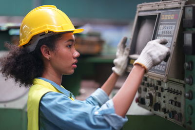 Side view of man working in factory