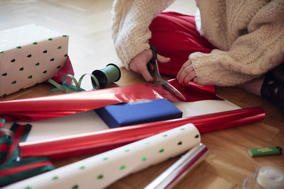 Woman's hands packing christmas presents