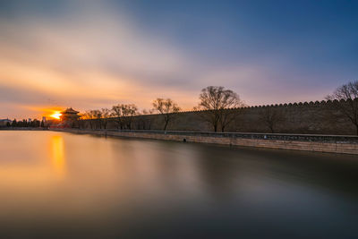 Scenic view of lake against sky during sunset