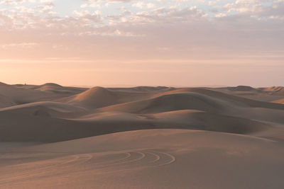 Scenic view of desert against sky during sunset