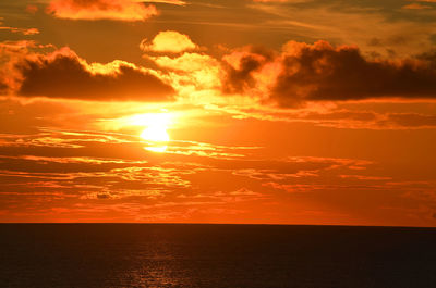 Scenic view of sea against romantic sky at sunset