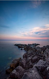 Scenic view of sea against sky at sunset