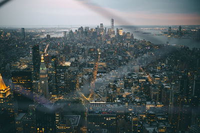 High angle view of city lit up at night