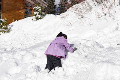 Rear view of woman in snow