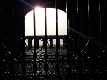 Silhouette metal grate on window