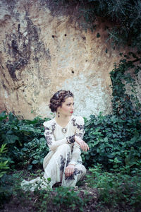 Portrait of a young woman sitting outdoors