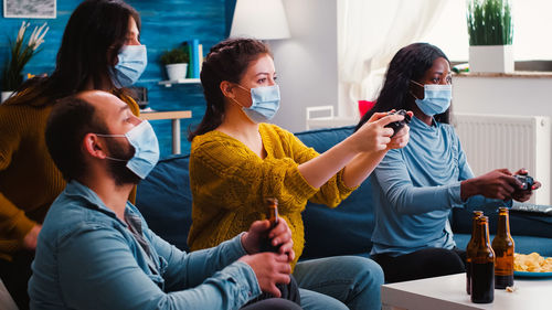 People using phone while sitting on sofa