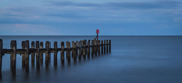 Scenic view of sea against cloudy sky