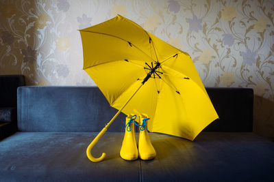 Yellow umbrella on wet table at home