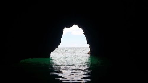 Scenic view of sea seen through arch