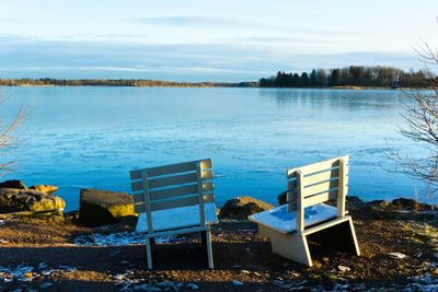 Empty bench in river