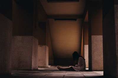 Man sitting on staircase of building