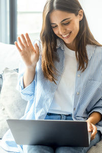 Young woman using laptop at home