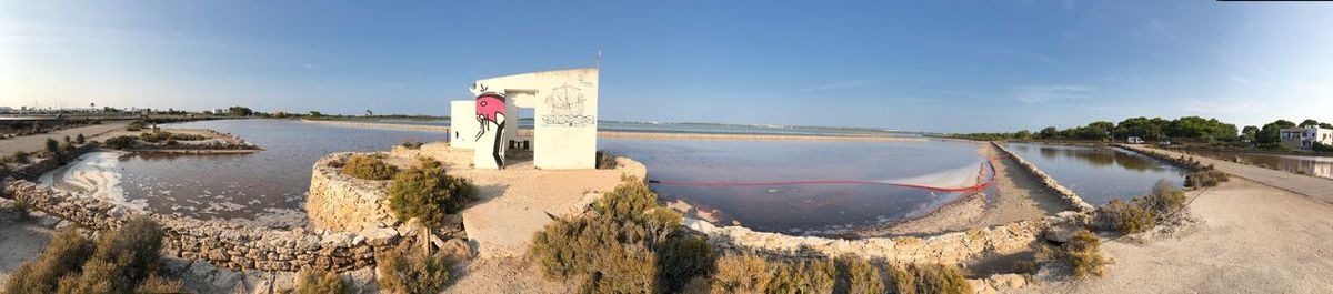 Panoramic view of sea and buildings against sky