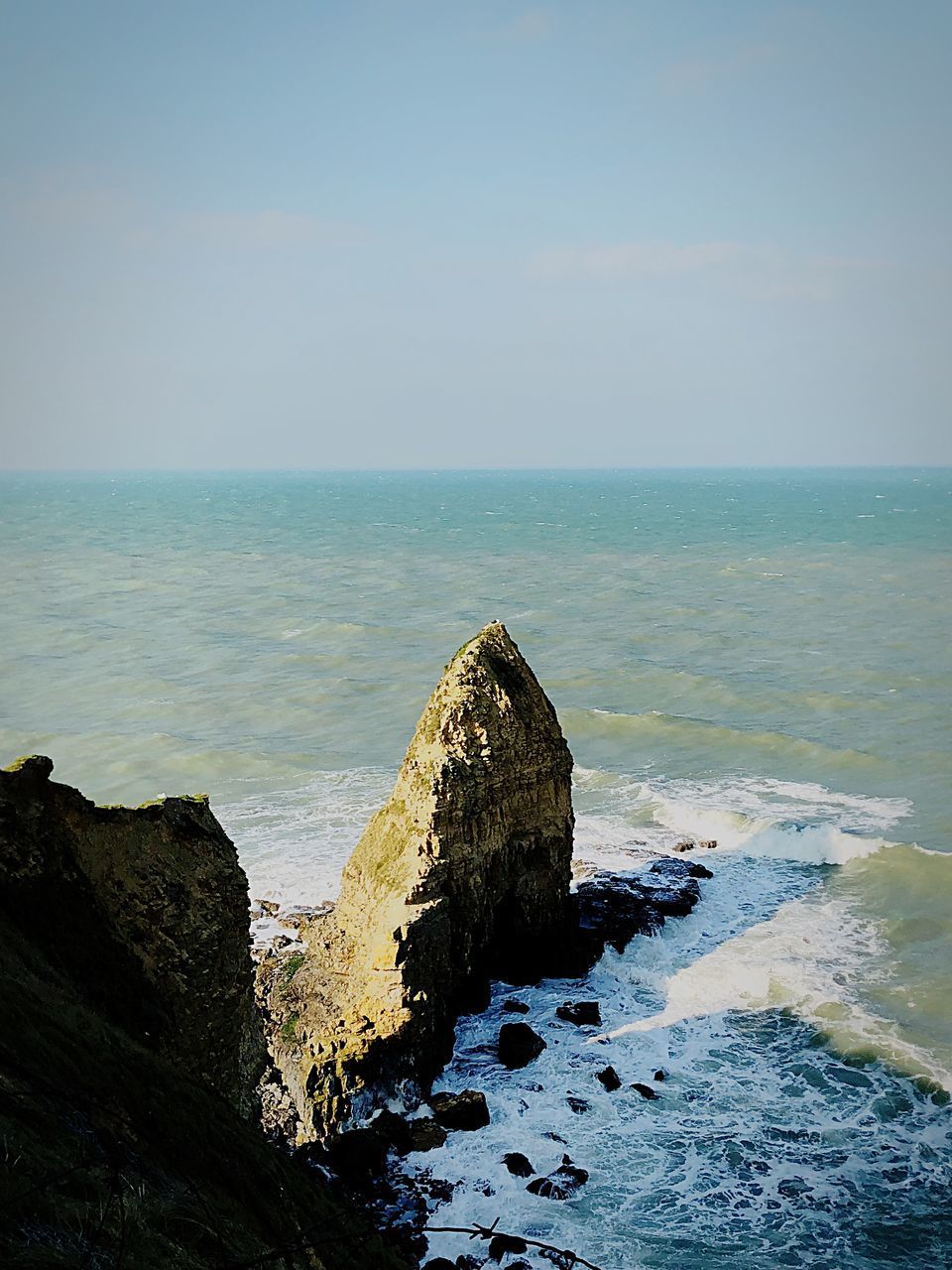 ROCKS ON BEACH AGAINST SKY