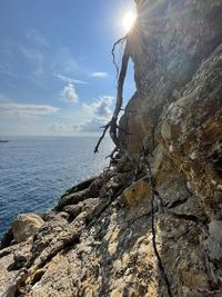 Scenic view of rock formation in sea against sky