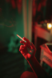 Close-up of hand holding cigarette