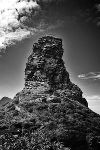 Low angle view of rock formation on land against sky