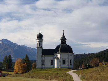 Church by building against sky