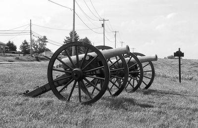 Cannons on field against sky