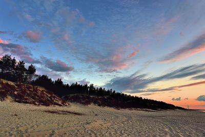 Scenic view of land against sky during sunset