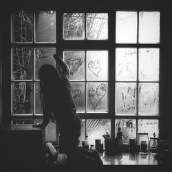 Woman looking through window