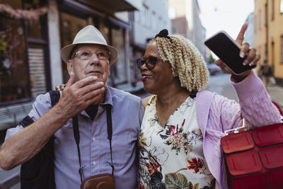 Heterosexual couple gesturing while exploring city