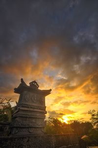 Low angle view of statue against sky during sunset