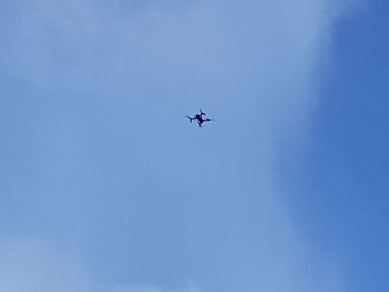 Low angle view of airplane flying in sky