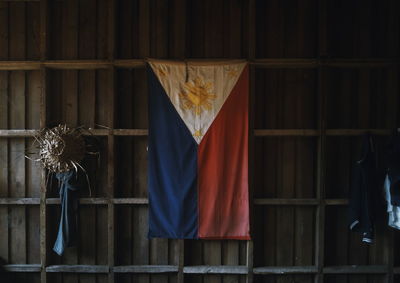 Philippines flag hanging from wooden wall