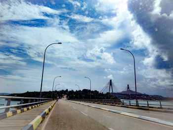 Street by highway against sky