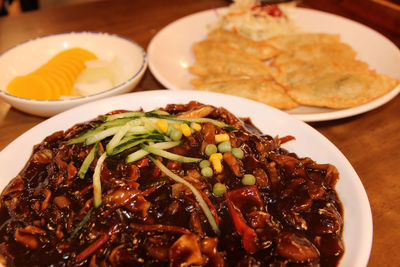 Jajangmyeon, korean black bean sauce noodles with the fried dumplings and pickled 