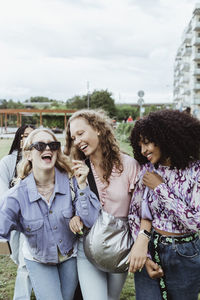Young woman standing against people in city