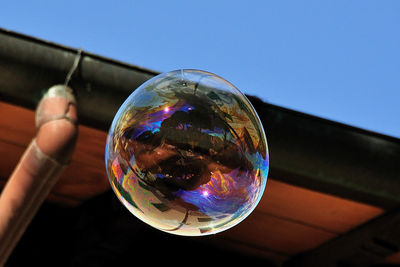 Close-up of bubbles in rainbow against sky