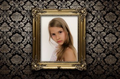 Photo frame of girl against patterned wall