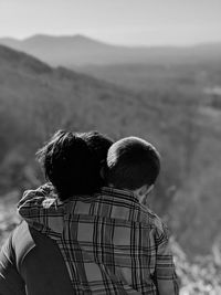 Rear view of man and woman looking at mountain