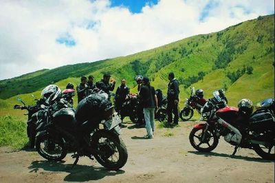 People riding motorcycle on road