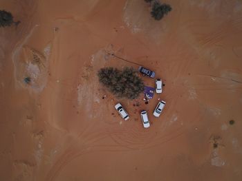 High angle view of cars parked on sandy field