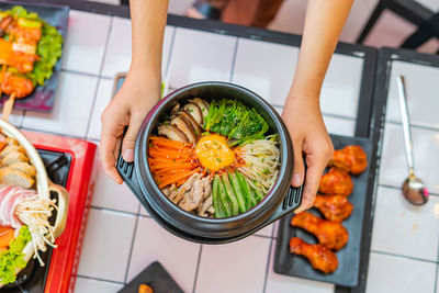 High angle view of woman preparing food on table