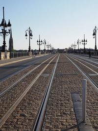 Rail tracks on historic bridge against clear sky