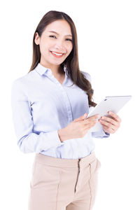 Portrait of a smiling young woman over white background