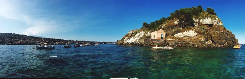 Panoramic view of sea against clear blue sky